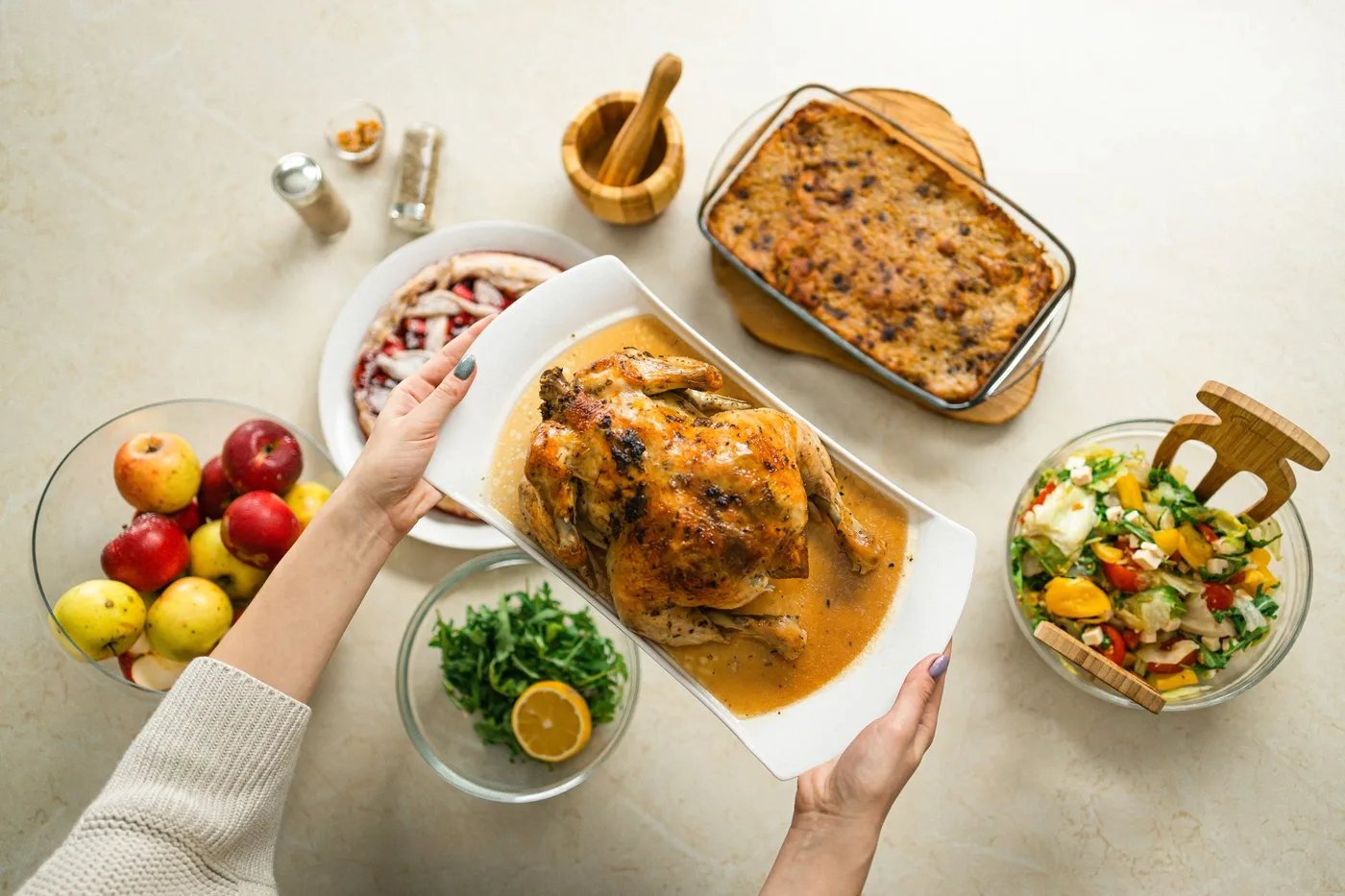 An appetizing spread featuring roasted chicken, fresh salad, and fruit for a perfect meal.