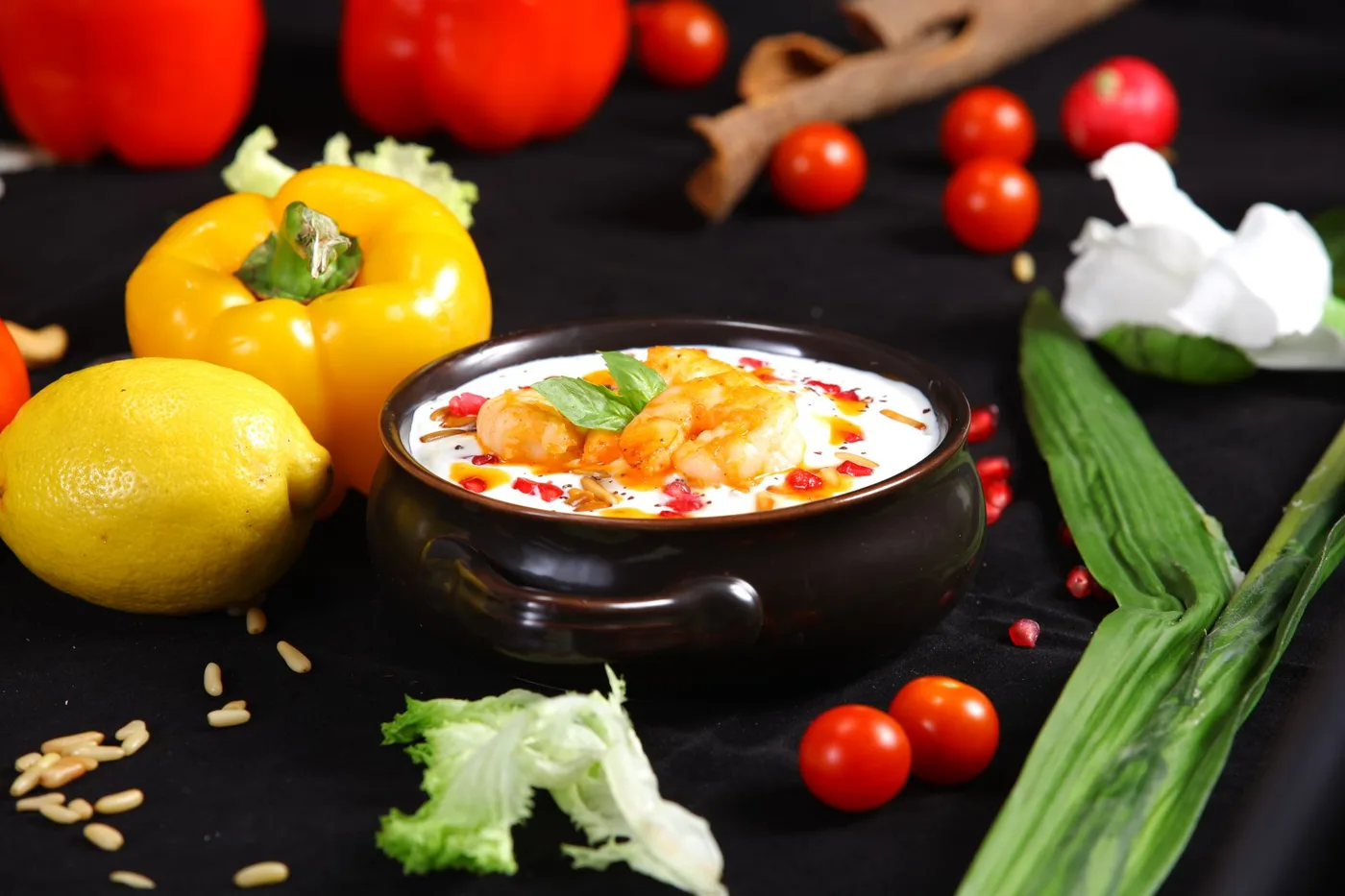 Close-up of a gourmet soup with vibrant vegetables and spices, ideal for food photography enthusiasts.