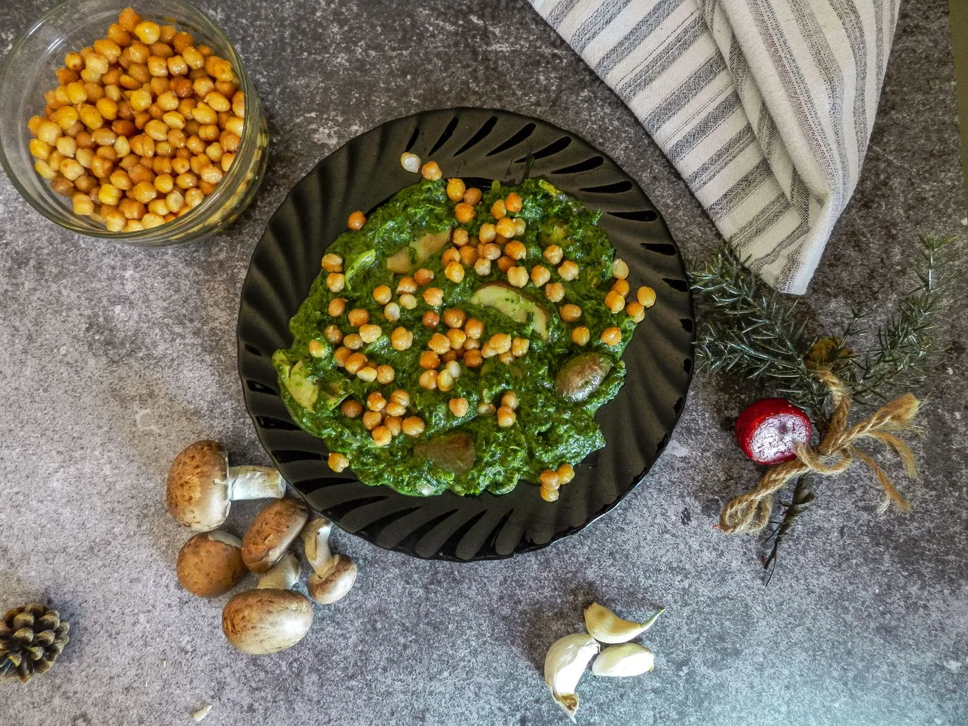 Delicious chickpea and spinach meal with mushrooms on a plate, perfect for healthy dining.